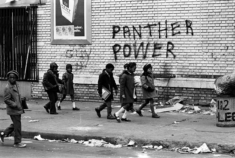 A group of seven small children walk to school with books in hand. From Stanley Nelson's 'The Black Panthers: Vanguard of the Revolution.' Photo courtesy of Stephen Shames.