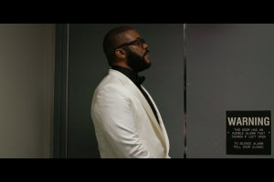 Tyler Perry film still in a white suite.