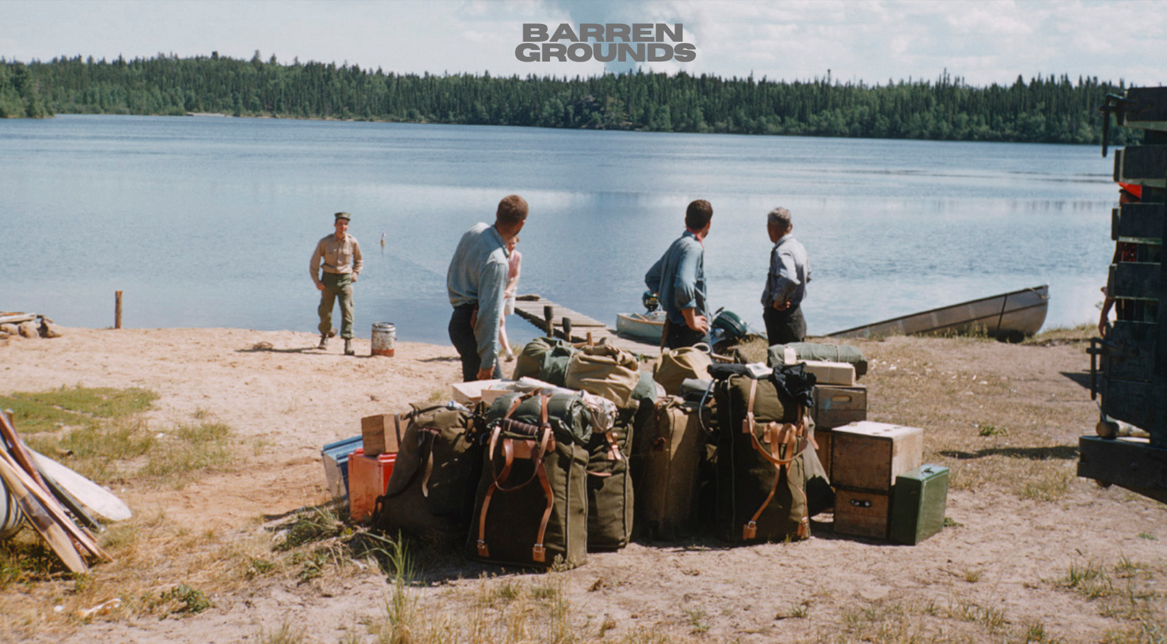 A group of people prepare for a canoe trip.