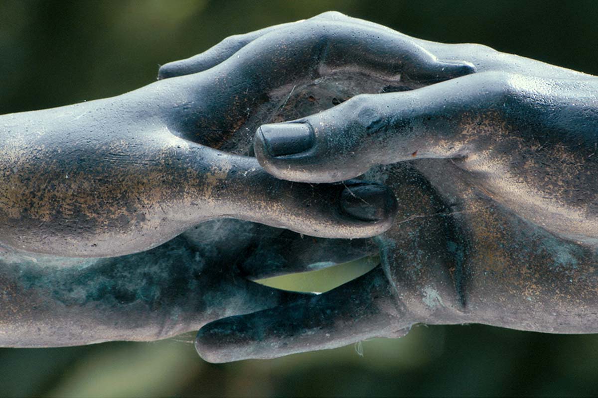 Detail from a black stone statue in Paris’ Père-Lachaise Cemetery, showing enclasped fingers of a figure. From Heddy Honigmann’s ‘Forever.’ Photo by Cobos Films, BV. Courtesy of Icarus Films. 