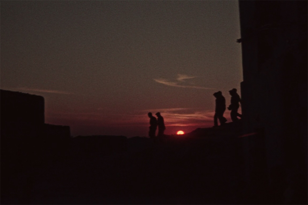 Silhouettes of six men against a setting sun. Image from Vittorio de Seta's 'Solfatara.' Courtesy of The Criterion Collection