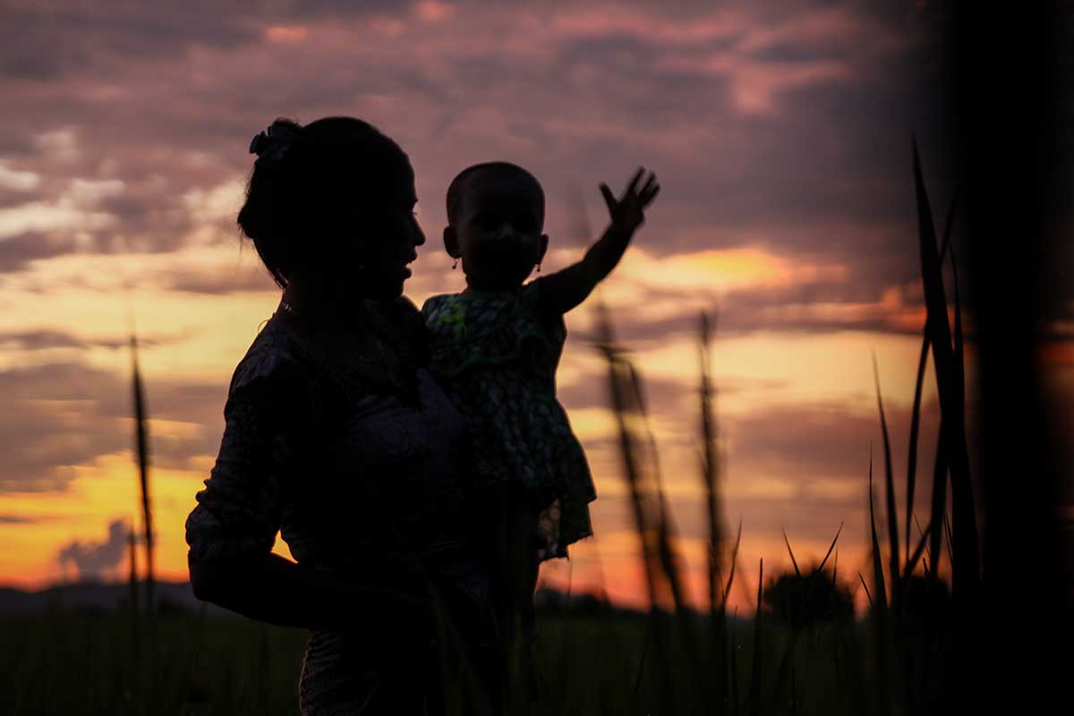 A silhouette of a woman holding a child against a sunset sky. From Hnin Ei Hlaing’s 'Midwives,' which recently played at Hot Docs. Courtesy of Hot Docs.