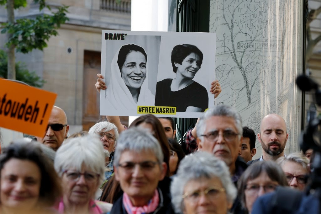 A protestor holds up a banner with Nasrin Sotoudeh’s photo. It says “Free Nasrin.” From 'Nasrin' (Director: Jeff Kaufman). Courtesy of David Magdael & Associates