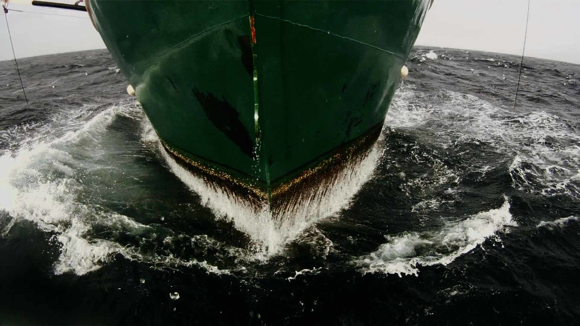 The bow of a ship in rough open seas.