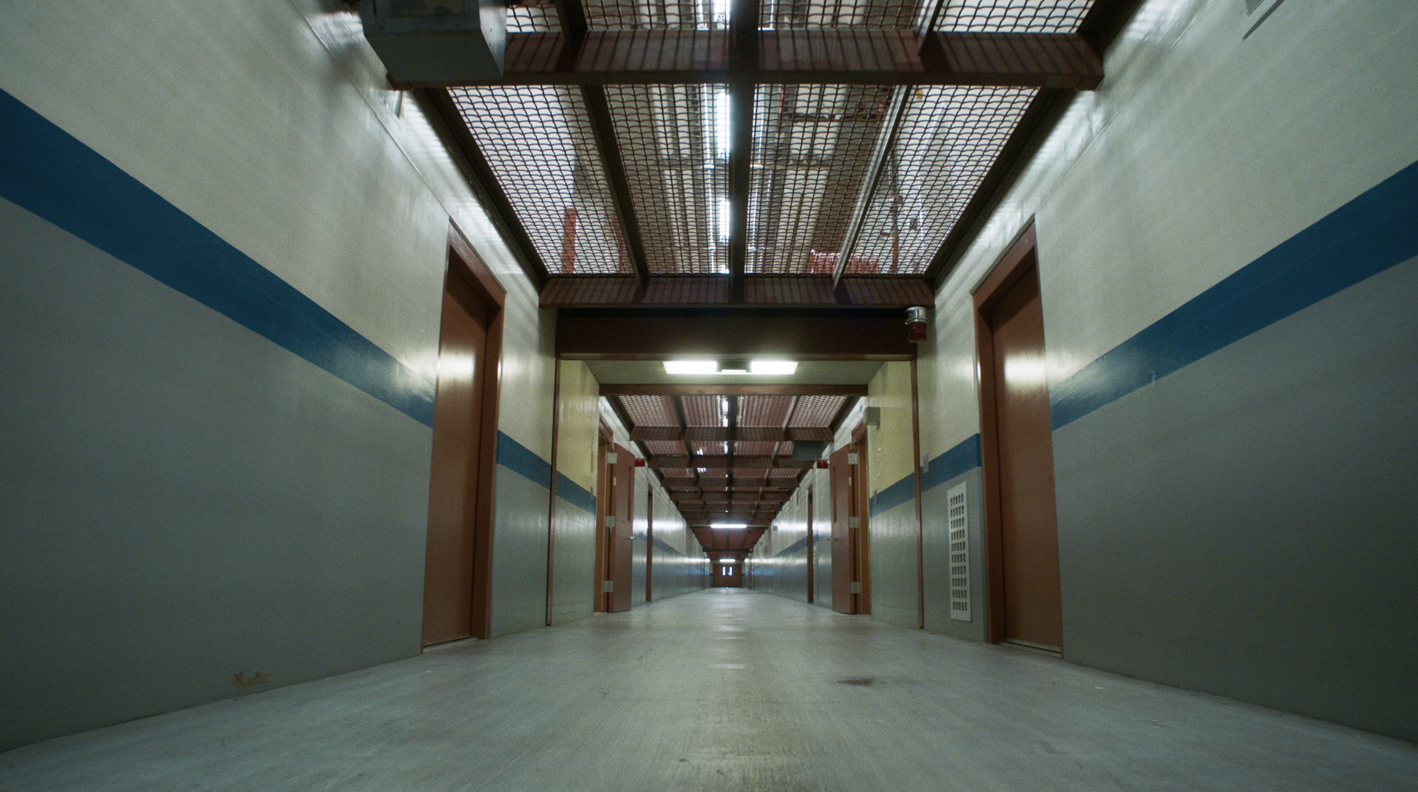 A film still from The Strike that shows the long bleak corridors of a prison.