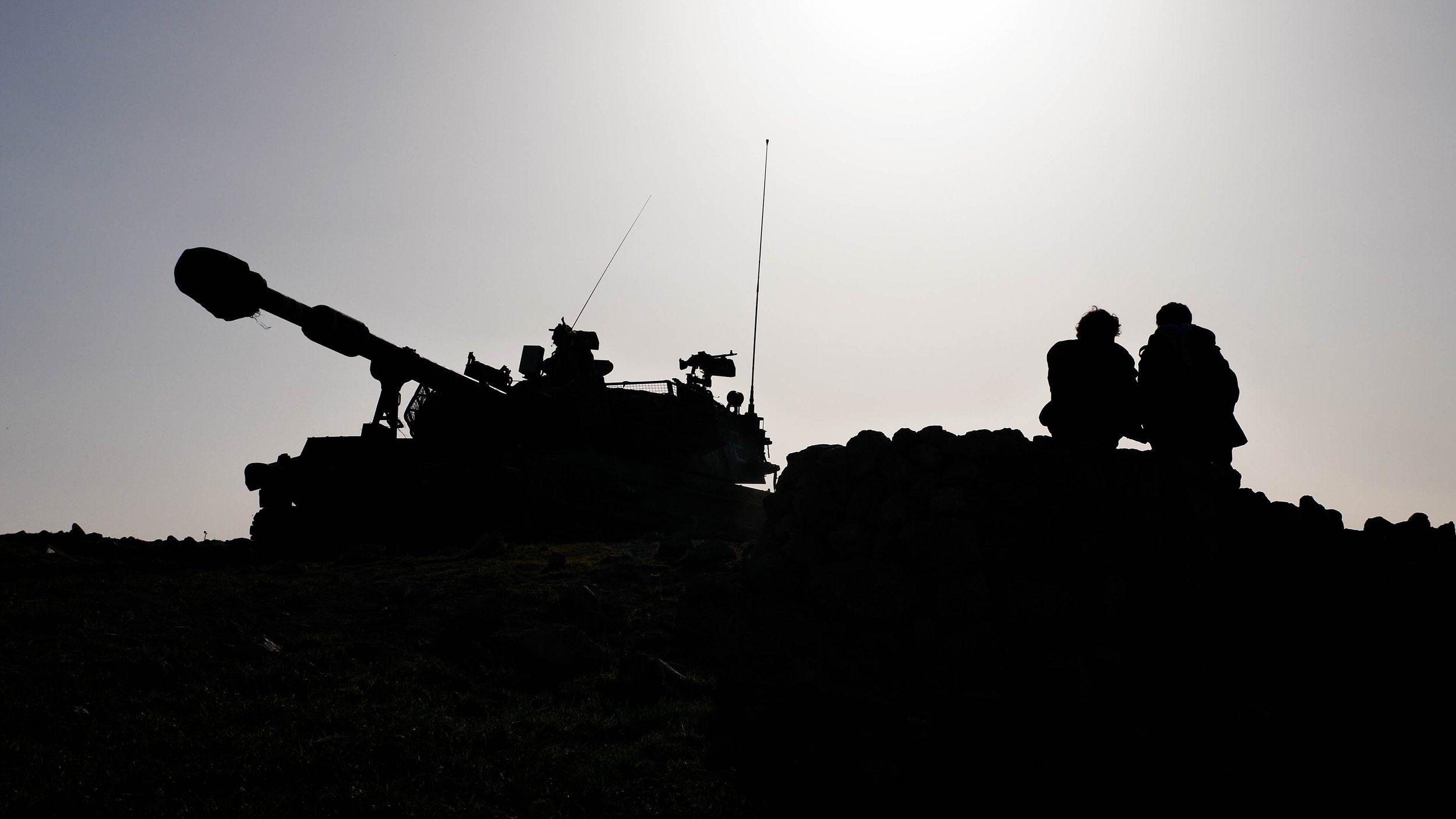 Silhouette of a tank and soldiers.