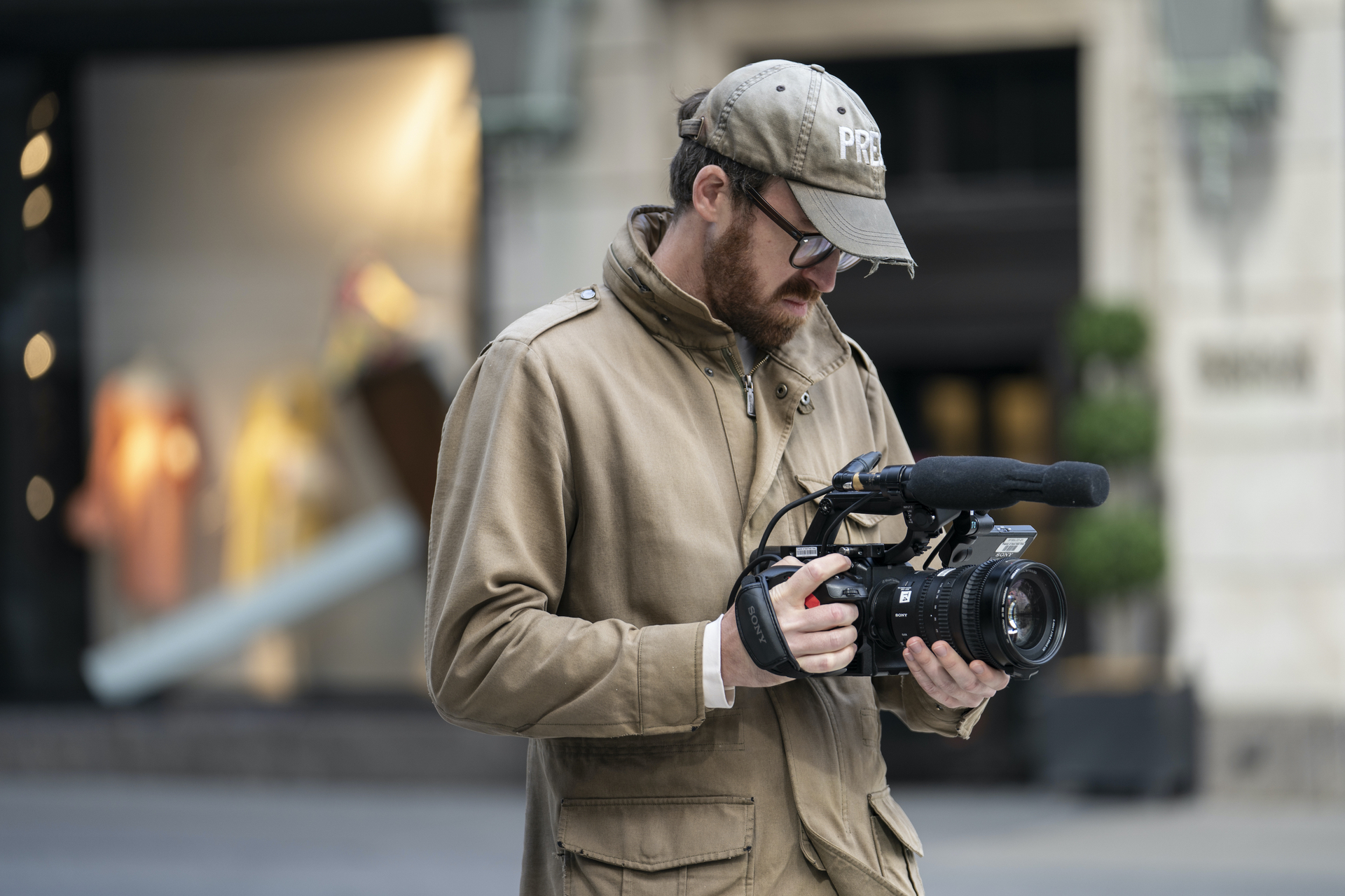 John Wilson holds a video camera.