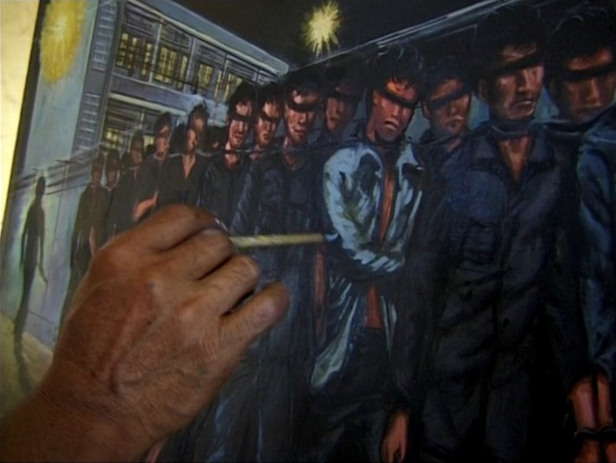 A hand paints.