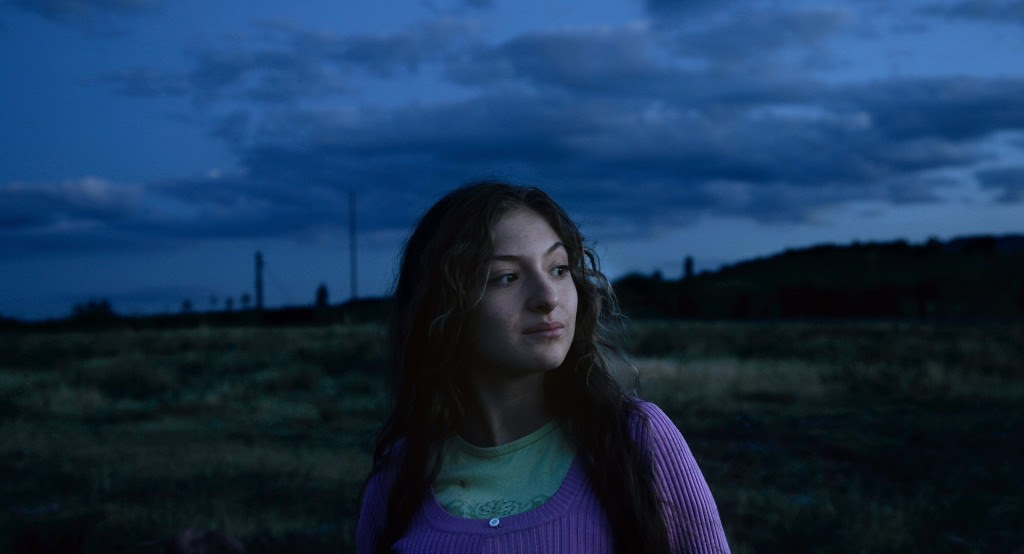 Twilight image of a young woman.