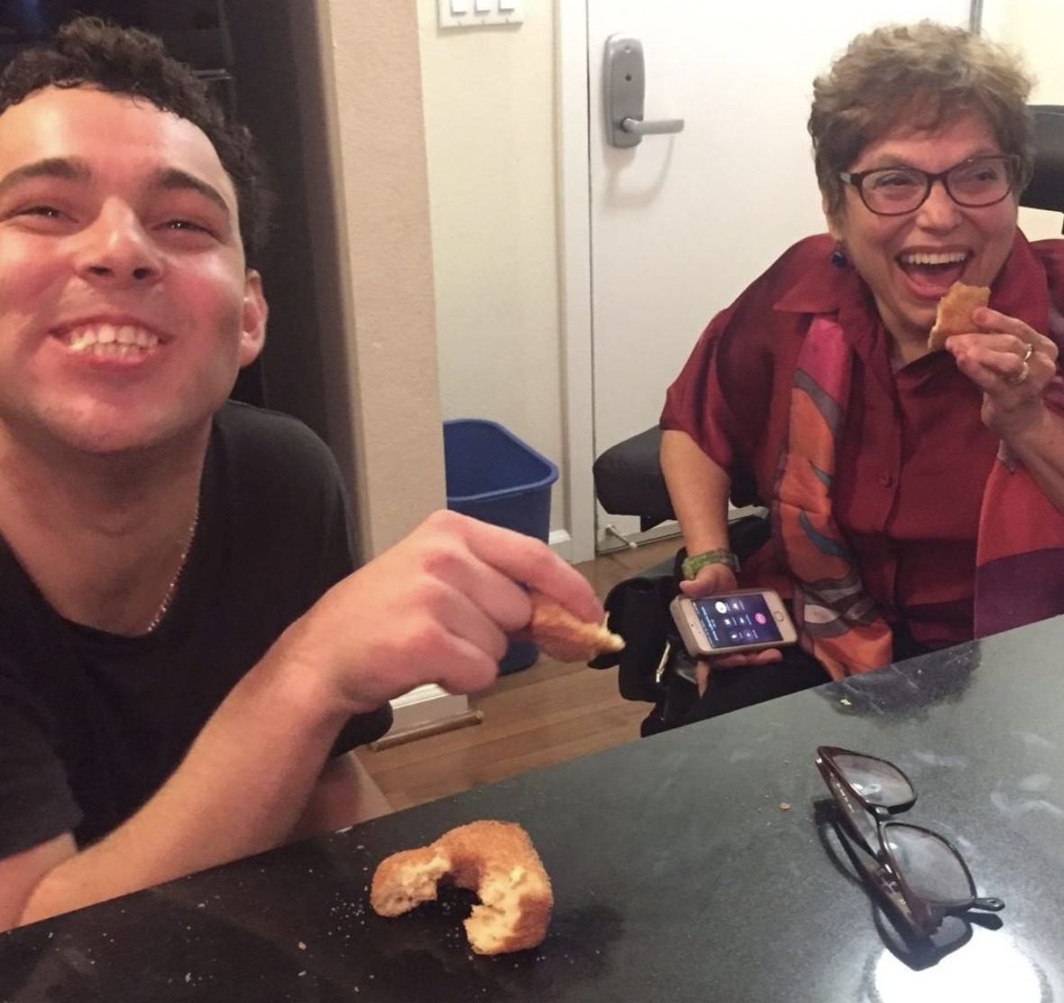 Reid and Judy laughingly eat donuts. Photo source: Reid Davenport