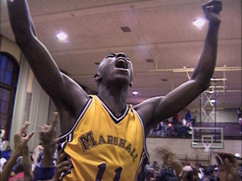 Arthur Agree, a Black high school basketball player, raises his arms in triumph. From 'Hoop Dreams' (Steve James, Frederick Marx, Peter Gilbert). Courtesy of Kartemquin Films