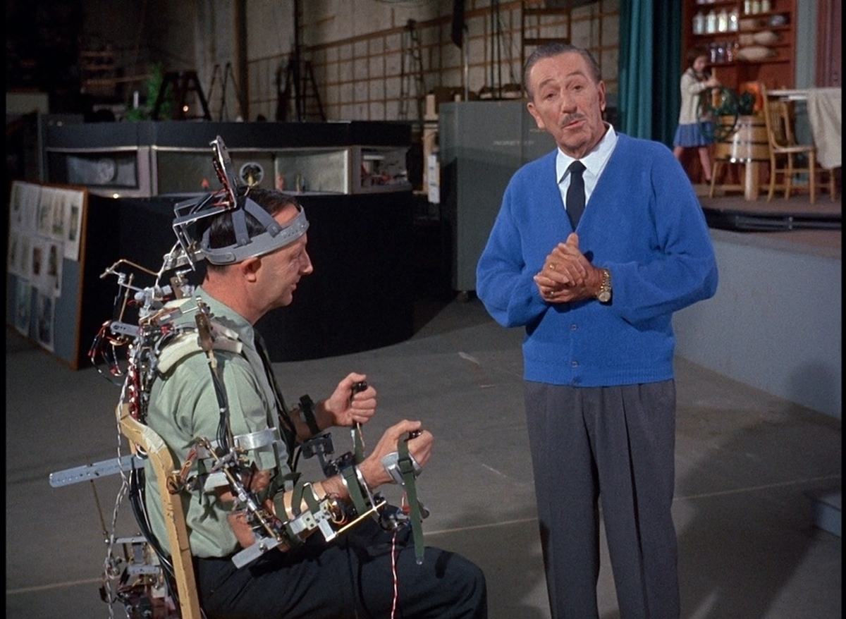 Walt Disney (right) with a Disney Imagineer, testing out animatronic gear. From Leslie Iwerks' 'The Imagineering Story.' Courtesy of Disney+