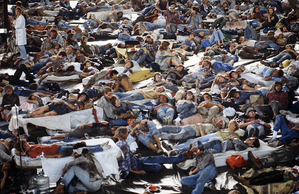 A crowd of injured people lying on the floor and mattresses. Still from 'The Day After' (1983), as seen in 'Television Event,' directed by Jeff Daniels, where doctors and nurses at a Kansas City hospital grimly witness the start of “World War III”, and anticipate being overwhelmed with patients while coping with no power, water or food. Courtesy of Getty Images.