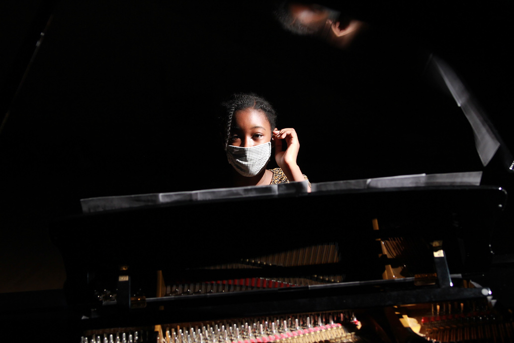 Grace Moore is a Black teenager with braided hair. She is wearing a mask and is sitting at a piano. Image from Arielle Knight’s ‘Song of Grace.’ Courtesy of Tribeca Festival