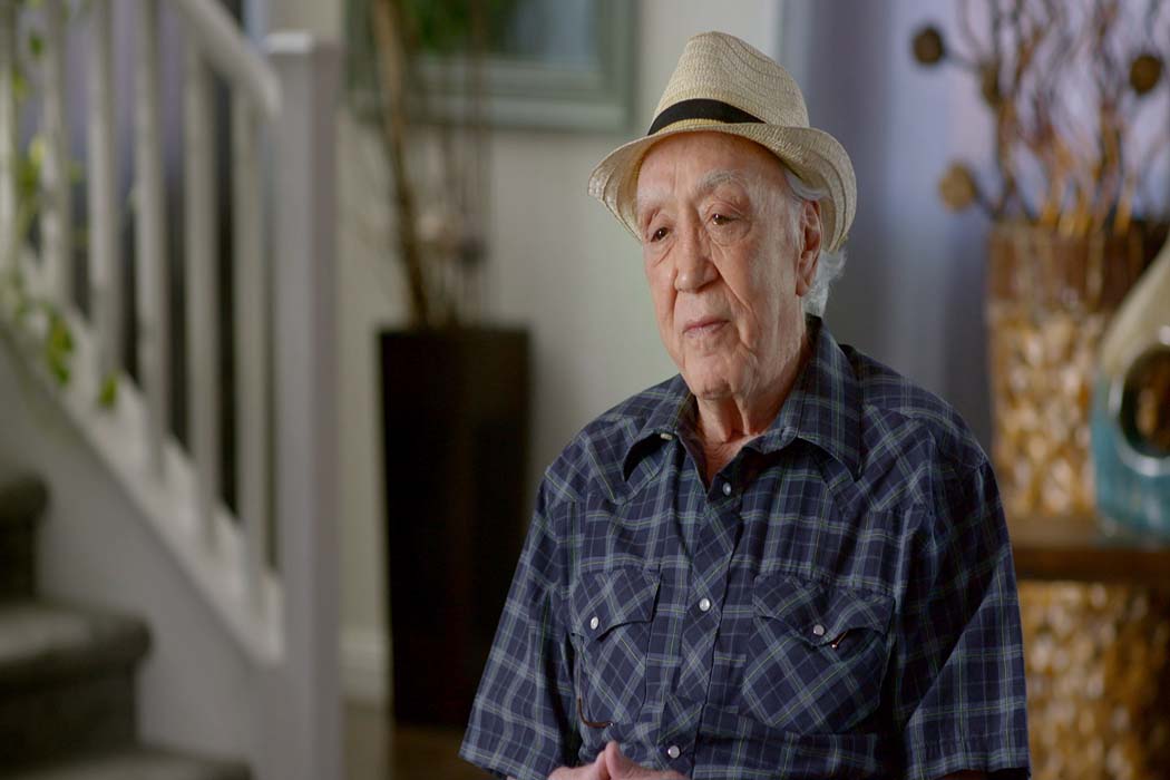 Al Victory is an elder white man wearing a blue checked shirt and a beige hat. Image from Stanley Nelson and Traci Curry’s ‘Attica.’ Courtesy of Showtime.