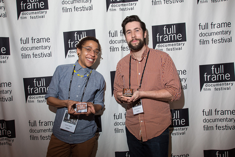 Lyric R. Cabral and David Felix Sutcliffe, with their Grand Jury Award for their film '(T)ERROR.' Courtesy of Full Frame Documentary Film Festival
