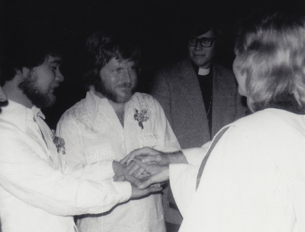 Reverend Frieda Smith marries Richard Adams (L) and Tony Sullivan (R) as Charles Arehardt looks on. Boulder, CO. April 21, 1975. Photo by Ron Wilson