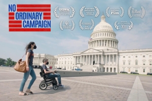 A woman, and a man in a wheelchair, in front of the US Capitol Building.