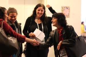 Photograph of Nancy Buirski greeting festival guests, with Laura Poirtras looking on, at Full Frame in 2009. Photo credit: Steve Bognar