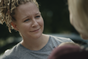 Film still from Reality Winner, of Reality Winner reuniting with her family after being released from prison. Image credit: E.J. Enríquez