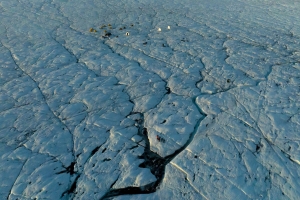 A Scientific Field Camp on The Greenland Ice Sheet, crisscrossed by crevasse traces and ice streams.