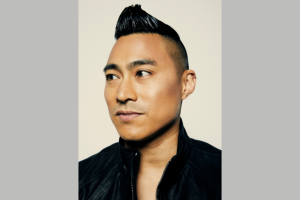 Headshot of a Filipino-American man with an undercut looking seriously into the distance.