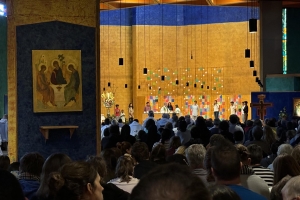 A crowd is gathered at a church for an evening prayer