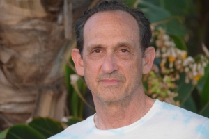 A middle aged man looking directly into the camera