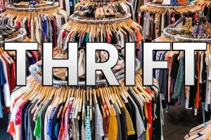 Stacks of clothes at a thrift shop