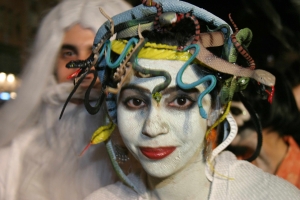 Participant in Greenwich Village Halloween Parade with white face paint and snakes in her hair.