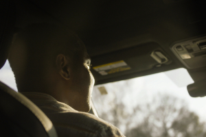 Close up of a man driving, shot from behind
