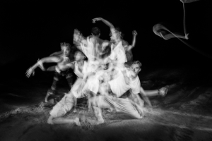 Juilliard dancers on the beach in a motion blur of gestures.