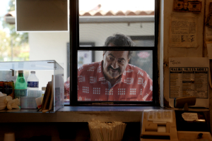 Ziad Karram peers through the front window of his old falafel shack, the Malibu Mutt.