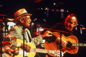 Two older men play guitar on stage, from Wim Wenders' 'Buena Vista Social Club.'
