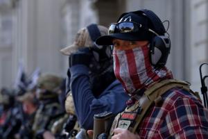 2 far-right extremists, dressed in flannel shirts, bullet-proof vests and baseball caps, outside the US Capitol on January 6.