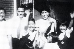 A blurry black-and-white family photo from 'Moving Memories.'