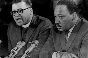 Reverend James Lawson sits and speaks next to Martin Luther King Jr. 