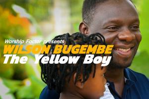 Close up of a Black man and child in front of a green background with the text "Wilson Bugembe: The Yellow Boy" superimposed over them