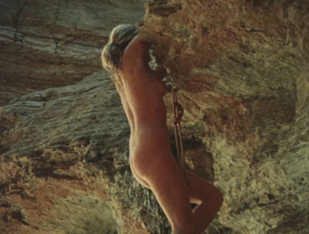 On 16mm, a nude woman climbs up a cliff. 