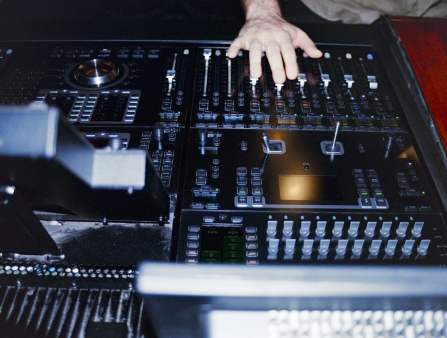 A hand on a mixing board.