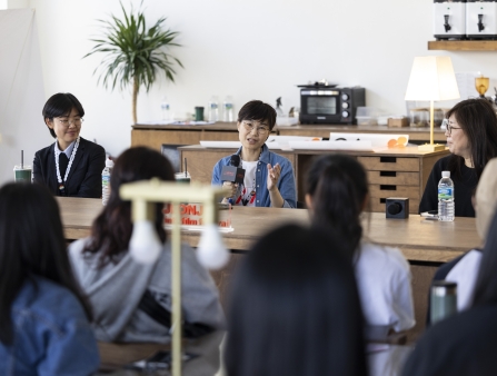 Three PINKS members giving a talk.