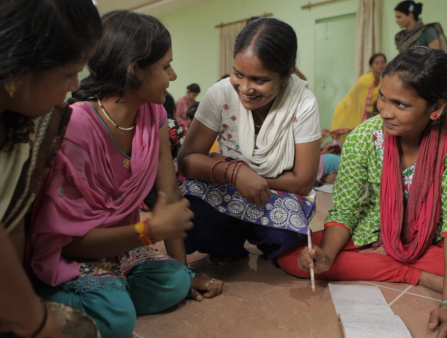 Four women discussing something energetically.