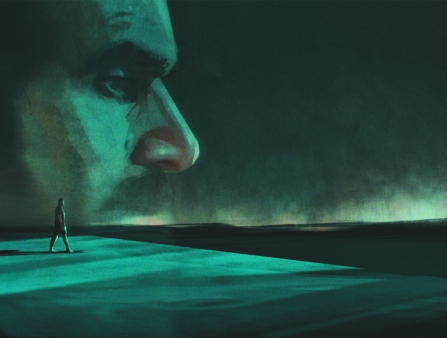A green-tinted animated still of a man walking far away with a giant spectral image of his face lighting up the night sky.
