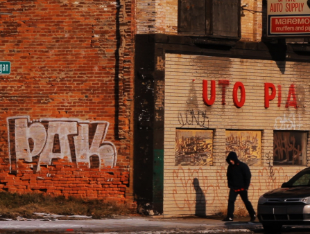 Graffiti on the side of a building with a sign that says "Utopia."