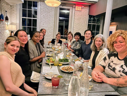 A group of filmmakers sit around a table at a restaurant.
