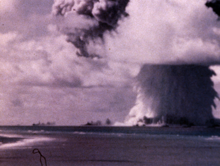 Purple-hued grayscale shot of a mushroom atomic bomb cloud