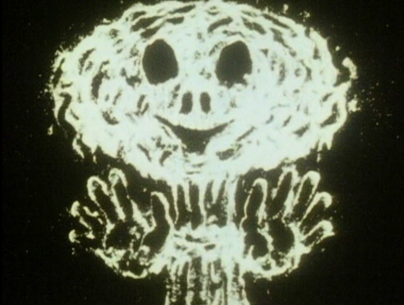 A white ghost-like version of an atomic mushroom cloud is seen against a black background
