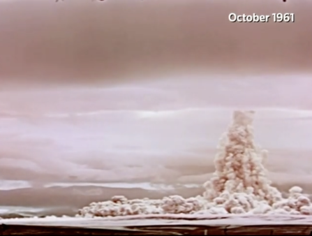 Bright pink-hued shot of an atomic mushroom cloud dated October 1961