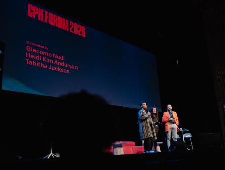 A Black woman with short-cropped hair, an Asian woman with long black hair, and a white man with short black hair (all smartly dressed) are dwarfed on stage by a screen behind them that reads "CPH:FORUM 2026"
