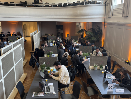 A large room of tables divided into numbered stations.